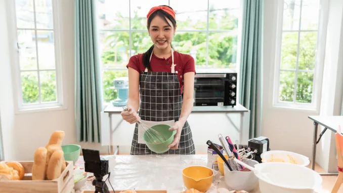Happy woman use fresh natural products flour milk eggs kneading dough for pastries cookies by hands at modern kitchen. Polyphenols in baked products.