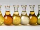 A collection of assorted glass bottles filled with vibrant liquids, ideal for illustrating chemistry concepts, scientific research, and laboratory environments. Lipases