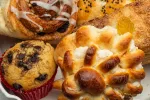 Close-up of a white plate with different freshly baked desserts, cinnamon roll, cupcake, and a sweet pastry. Use fat replacers. baking powder, leavening agents