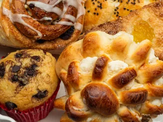 Close-up of a white plate with different freshly baked desserts, cinnamon roll, cupcake, and a sweet pastry. Use fat replacers. baking powder, leavening agents