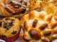 Close-up of a white plate with different freshly baked desserts, cinnamon roll, cupcake, and a sweet pastry. Use fat replacers. baking powder, leavening agents