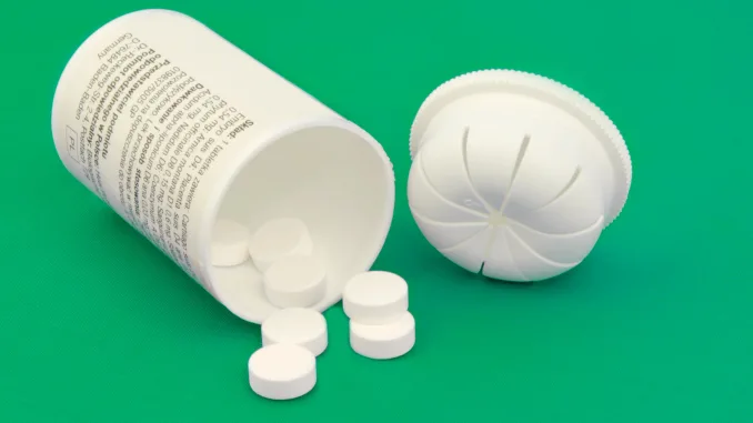 Pill Medicine and Bottle on green background. Nitazines