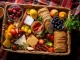 overhead view of a wicker picnic basket filled with sandwiches, fruits, and drinks, created with generative ai