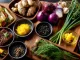 An overhead shot of various herbs, spices, and small dishes on a wooden surface