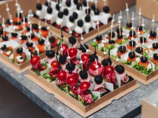 Catering table, beautifully decorated banquet with variety different food snacks appetizers on christmas corporate birthday party event or wedding celebration, canape, salad, delicatessen setting. Hors d'oevres